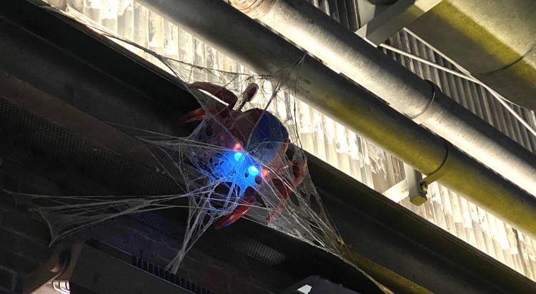 Spider-Bot caught in webs outside WEB headquarters.