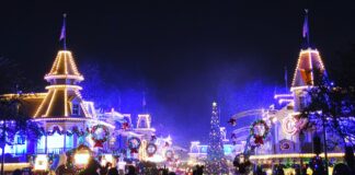 Fake snow falls on Main Street USA at the Magic Kingdom.