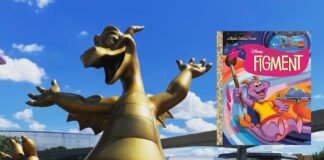 Figment sculpture at EPCOT with the Figment Little Golden Book.