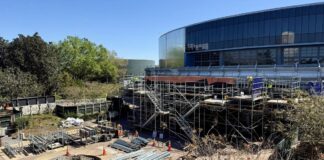 Construction taking place on the outside of the updated Test Track at EPCOT.