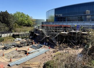 Construction taking place on the outside of the updated Test Track at EPCOT.