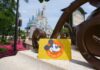Disney World Raises Prices on All Annual Passes Annual pass card in front of Cinderella Castle.