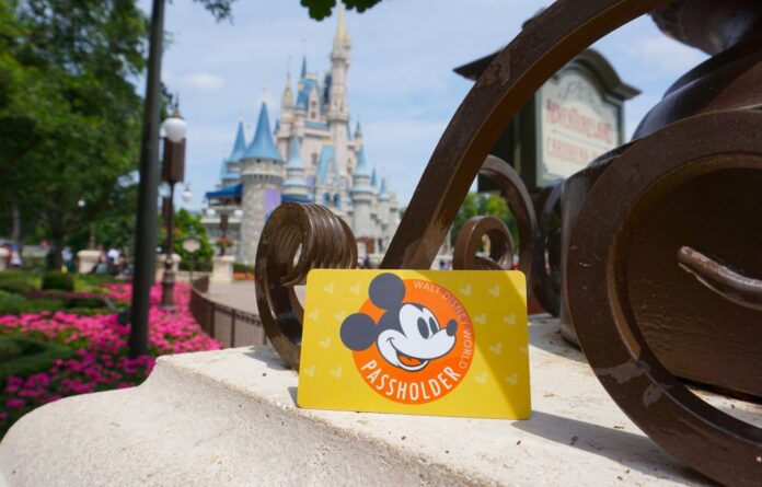 Annual pass card in front of Cinderella Castle.