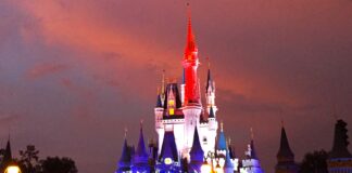 Disney World Expands July 4th Fireworks to 3 Nights at Magic Kingdom and EPCOT Nighttime view of Cinderella Castle with red, white, and blue lighting.