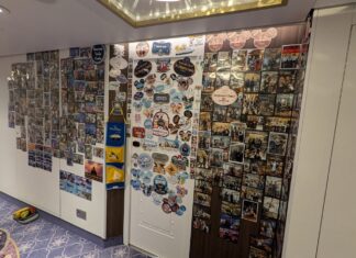 Disney Cruise Line Updates Door Decorating Policy to Ban Hallways and Ceilings Family pictures cover a wall outside a Disney Cruise Line stateroom door.