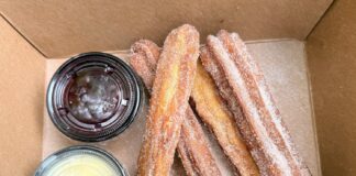 Here’s Where You Can Find the Best Churros in Disney World Box of churros and dipping sauces from Nomad Lounge.